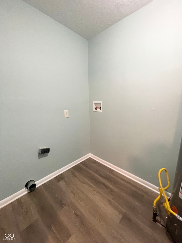 clothes washing area featuring dark hardwood / wood-style flooring, hookup for a washing machine, and a textured ceiling