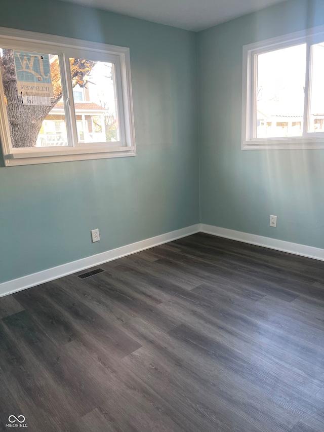 unfurnished room featuring dark wood-type flooring