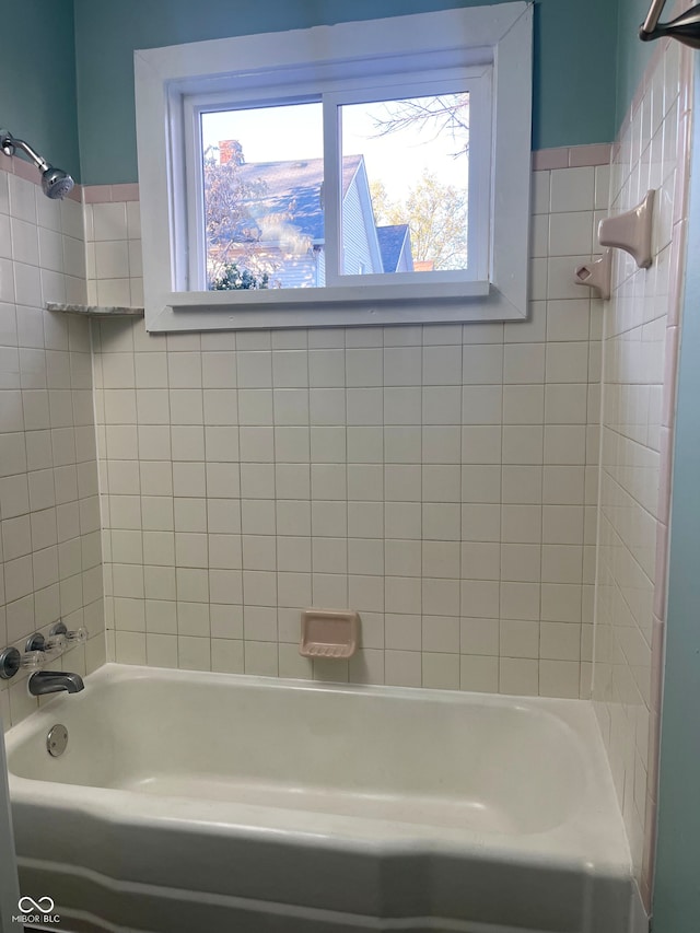 bathroom featuring tiled shower / bath and a healthy amount of sunlight