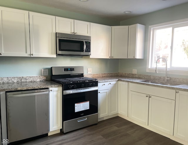 kitchen featuring dark wood-type flooring, white cabinetry, sink, and appliances with stainless steel finishes