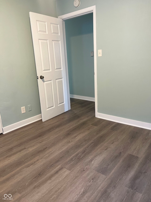 empty room with dark hardwood / wood-style floors