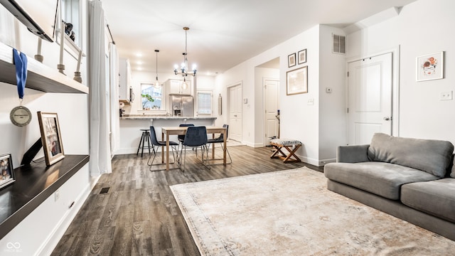 living area featuring baseboards, visible vents, and dark wood-style floors