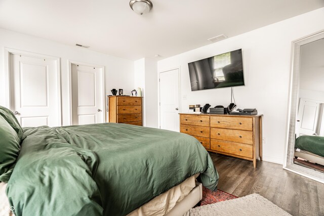 bedroom with visible vents and dark wood-style floors
