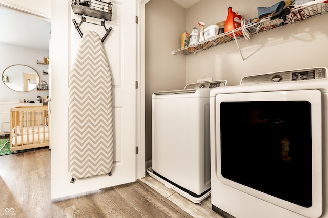 laundry room featuring light wood-style floors, laundry area, and washer and clothes dryer
