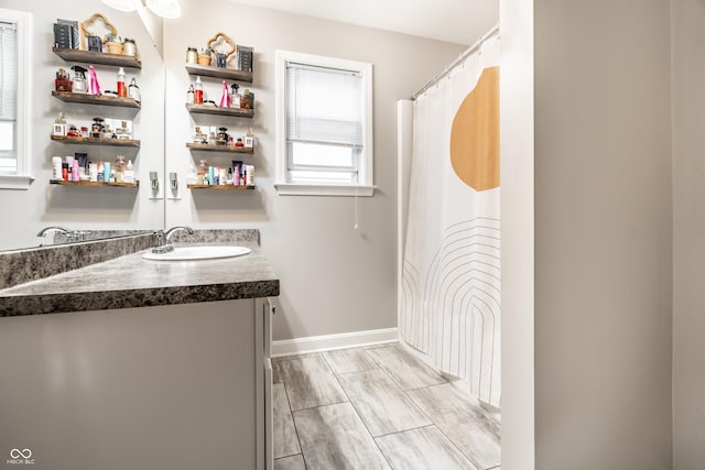 full bathroom with baseboards and vanity