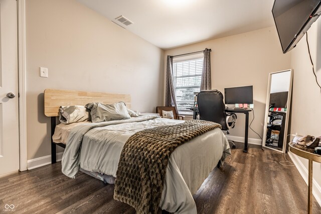bedroom with dark wood-style flooring, baseboards, and visible vents