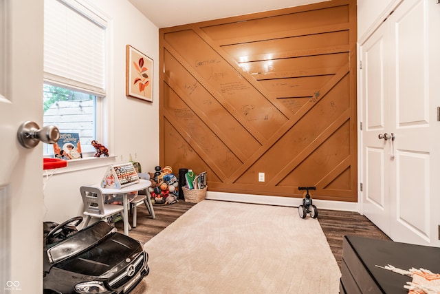 game room with dark wood-style floors