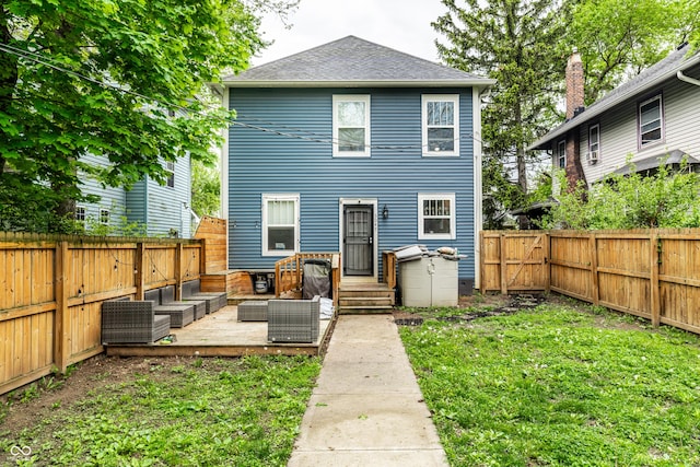 back of house with a fenced backyard, an outdoor hangout area, a shingled roof, and a lawn
