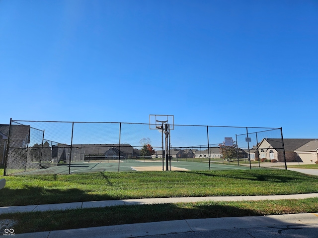 view of sport court with a yard