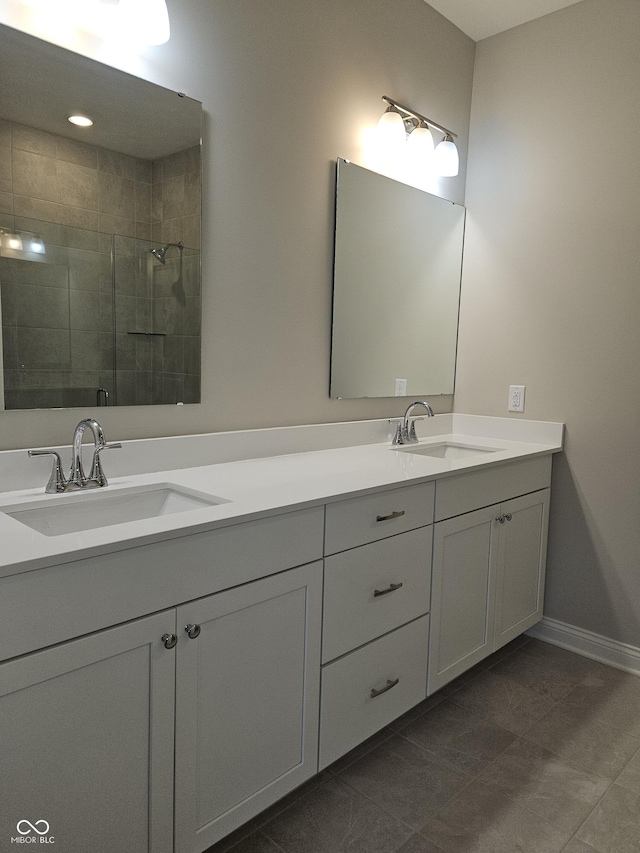 bathroom with walk in shower, tile patterned floors, and vanity