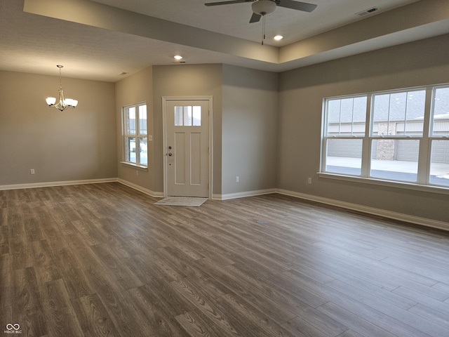 foyer entrance featuring dark wood-type flooring and ceiling fan with notable chandelier