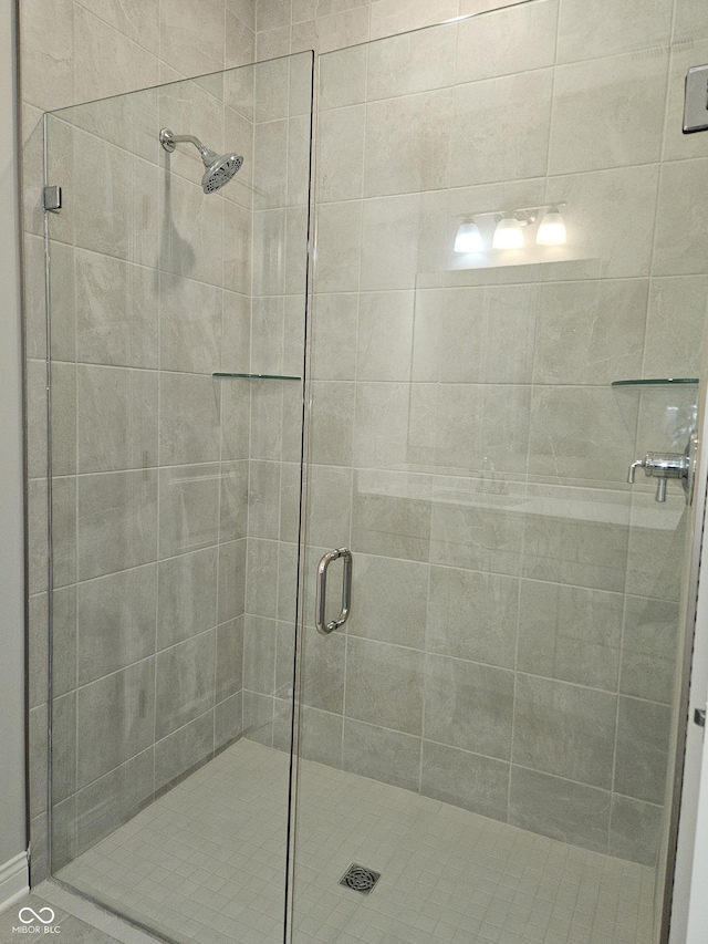 bathroom featuring a shower with door