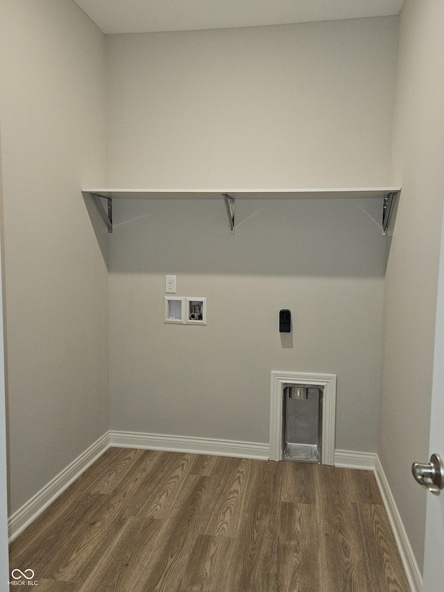 washroom with hookup for a washing machine, electric dryer hookup, and dark wood-type flooring