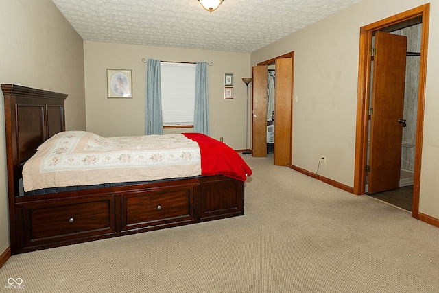 carpeted bedroom featuring a textured ceiling