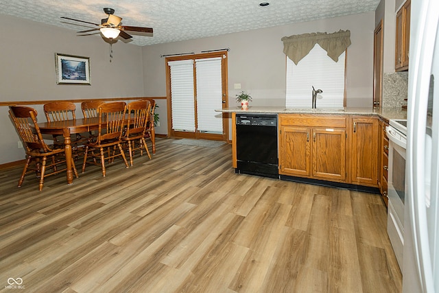 kitchen featuring a textured ceiling, ceiling fan, sink, dishwasher, and light hardwood / wood-style floors