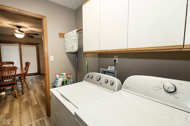 laundry area with cabinets, wood-type flooring, separate washer and dryer, and ceiling fan