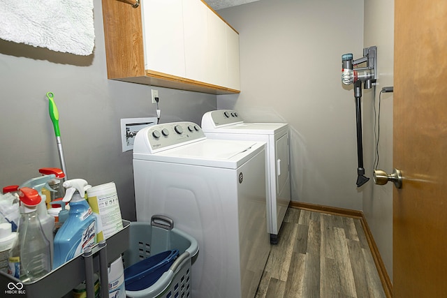 laundry area with dark wood-type flooring, cabinets, and independent washer and dryer