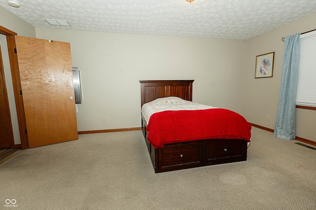 carpeted bedroom featuring a textured ceiling