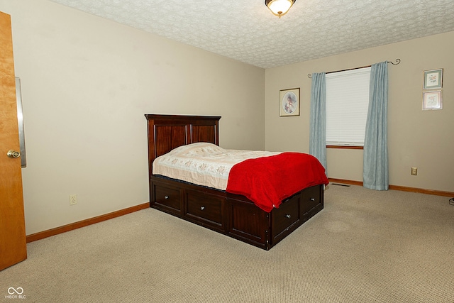 carpeted bedroom featuring a textured ceiling