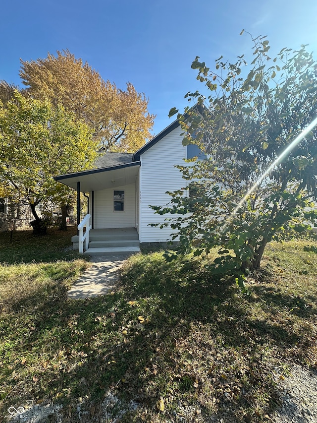 rear view of property with a yard