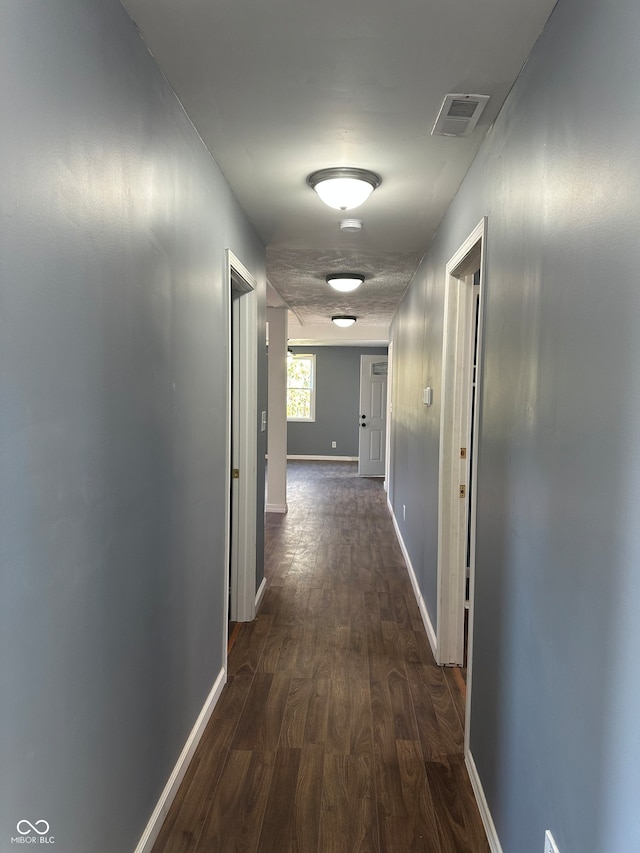 hall featuring dark wood-type flooring