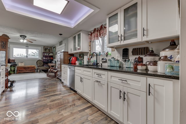 8190 Beech Grove Rd, Martinsville, IN 46151 - kitchen featuring stainless steel dishwasher, healthy amount of natural light, white cabinetry, and light wood-style floors