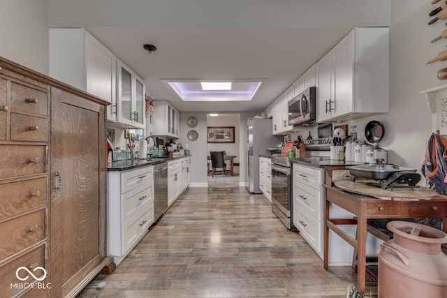 8190 Beech Grove Rd, Martinsville, IN 46151 - kitchen with stainless steel appliances, dark countertops, wood finished floors, glass insert cabinets, and white cabinets