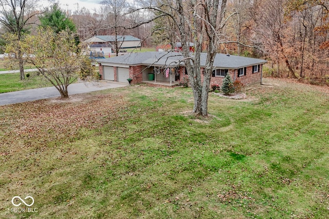 ranch-style home with a garage and a front yard