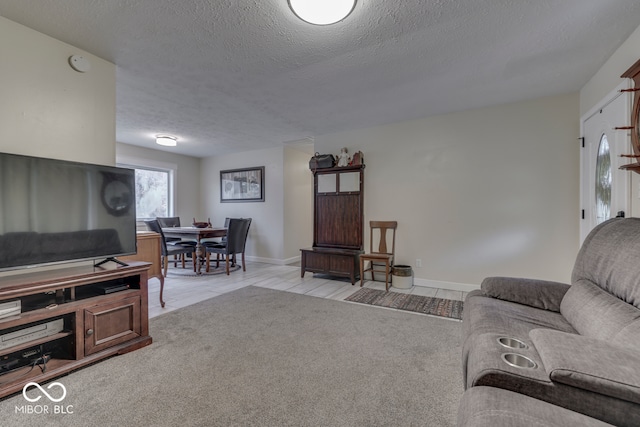 carpeted living room featuring a textured ceiling