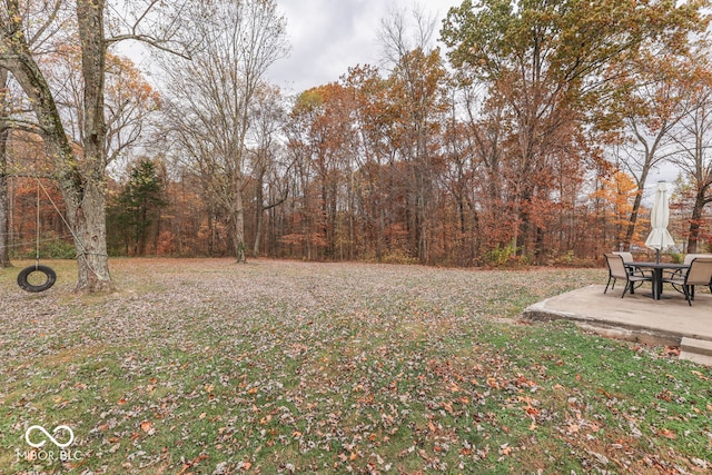 8190 Beech Grove Rd, Martinsville, IN 46151 - view of green lawn featuring a patio and a wooded view