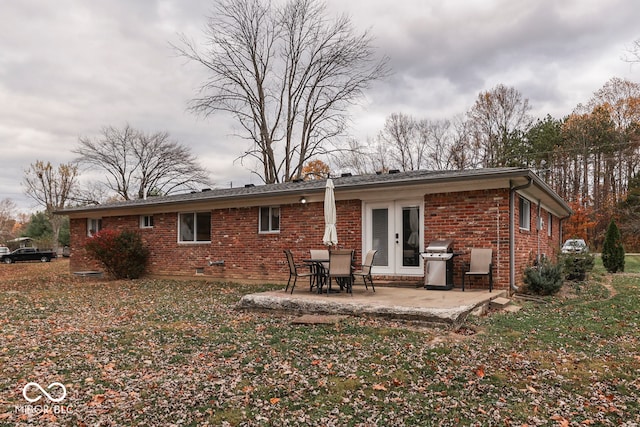 rear view of property with a patio area and french doors