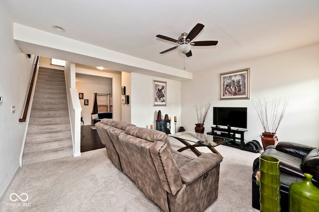 carpeted living room with ceiling fan