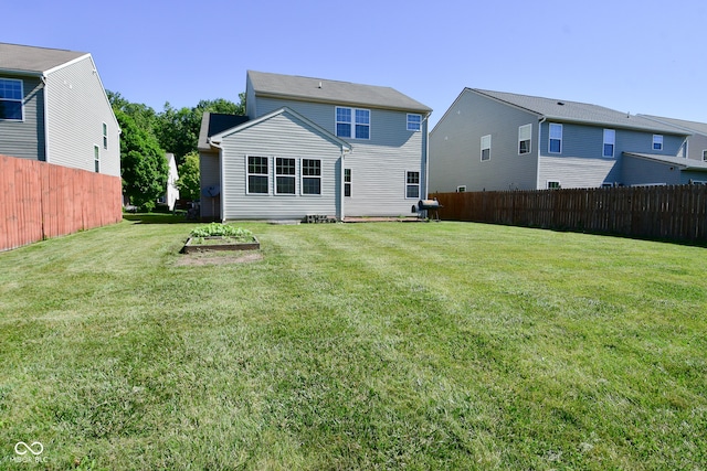 rear view of property featuring a lawn