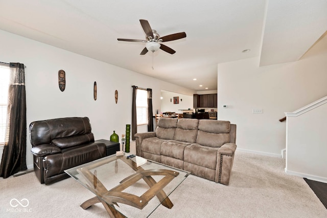 carpeted living room featuring ceiling fan