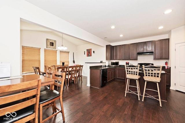 kitchen featuring dark hardwood / wood-style floors, an inviting chandelier, dark brown cabinets, lofted ceiling, and pendant lighting