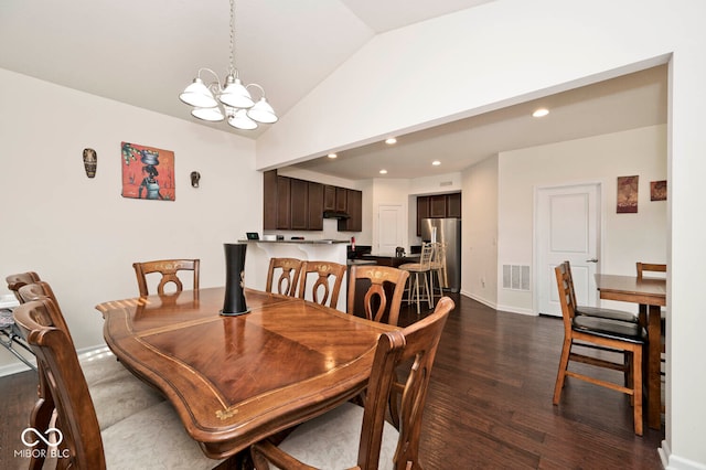 dining space featuring dark hardwood / wood-style floors, a chandelier, and lofted ceiling