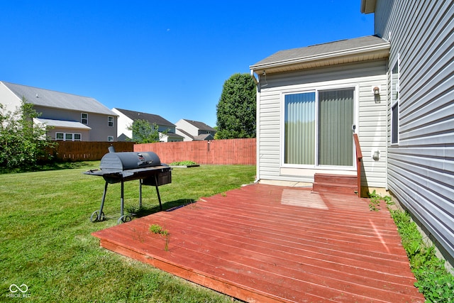 wooden terrace with a yard and grilling area