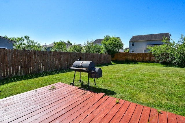 deck featuring a lawn and a grill