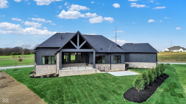 view of front facade with a patio and a front yard