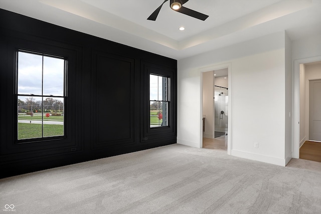 carpeted empty room featuring ceiling fan