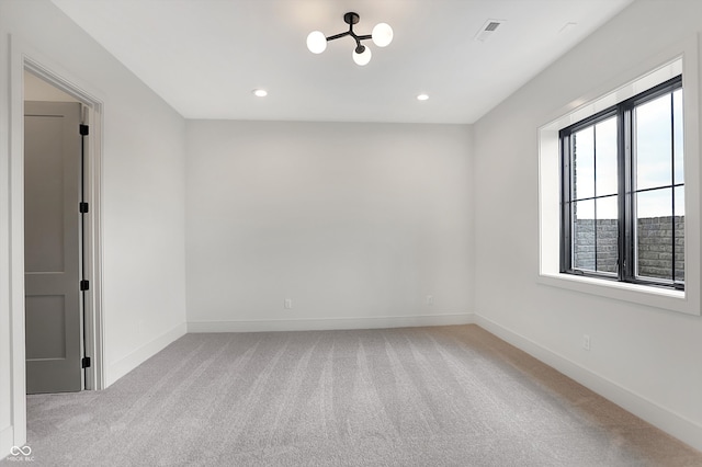 unfurnished room with light colored carpet