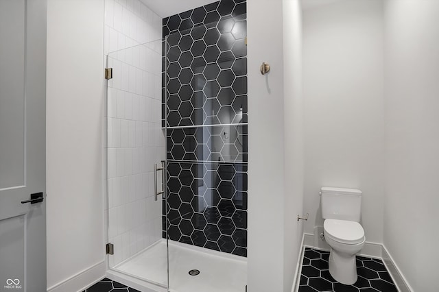 bathroom with tile patterned flooring, an enclosed shower, and toilet