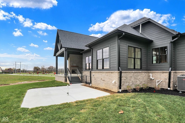 view of home's exterior with central AC unit, a lawn, and a patio