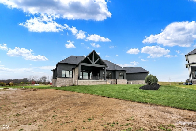 back of house featuring a lawn