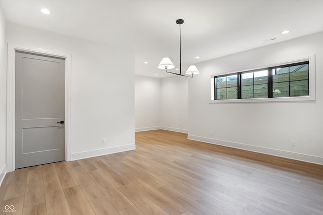 spare room featuring light hardwood / wood-style flooring