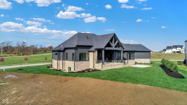 back of property featuring a yard and a patio