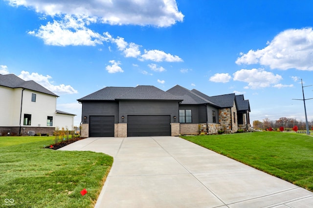 view of front of house featuring a front yard and a garage