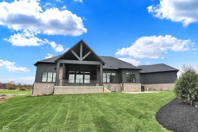 rear view of house with a yard and a patio area