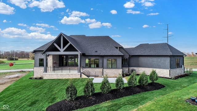 view of front of home with a front yard and a patio area