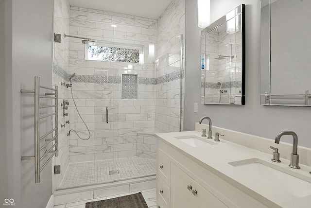 bathroom with vanity and a shower with shower door